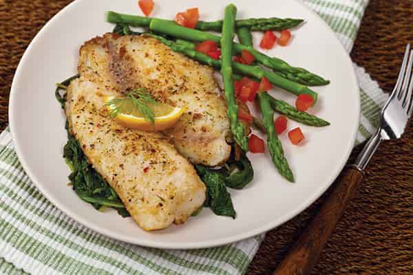 Delightful Baked Fish Recipe with lemon pepper and onions.