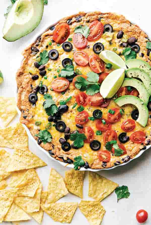 Texas Trash Dip Image with Recipe. Made with Mexican cheese, taco seasoning mix, refried beans and more. Great dish to serve at football games!