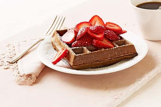 Chocolate Belgian Waffles are rich, moist and delicious. Topped with strawberries, every bite is a taste of goodness.