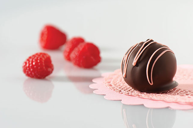 OREO-Raspberry Cookie Balls are dipped and drizzled in chocolate.